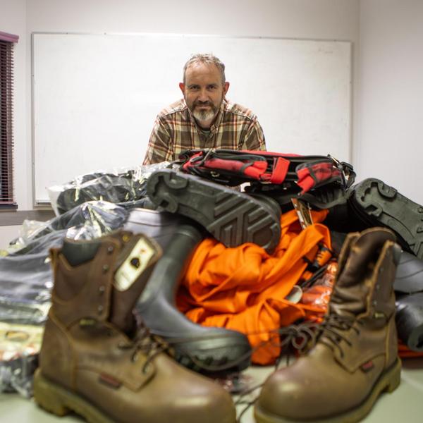 Staff showing off field gear